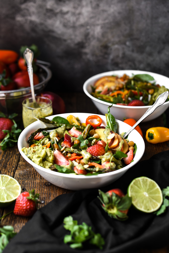 Photo of a coclorful salad for Spring. Salad recipe with strawberries, asparagus, peaches, dressing, spinach, and peppers. Springtime Vibes Salad+Cilantro Almond Butter Dressing (Vegan+GF)